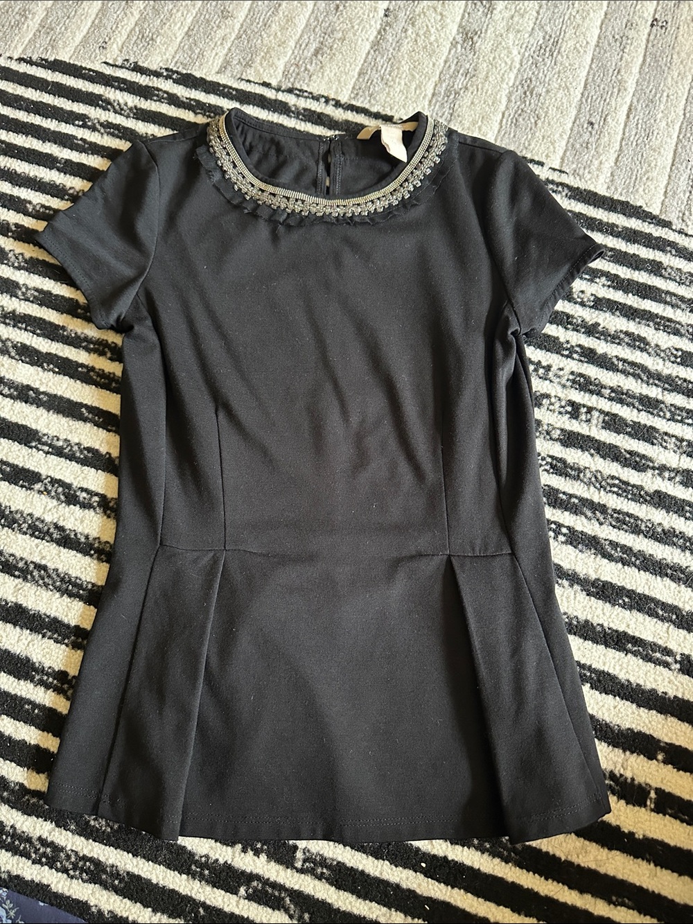 Black Embellished Neck Short Sleeve peplum top. 00P